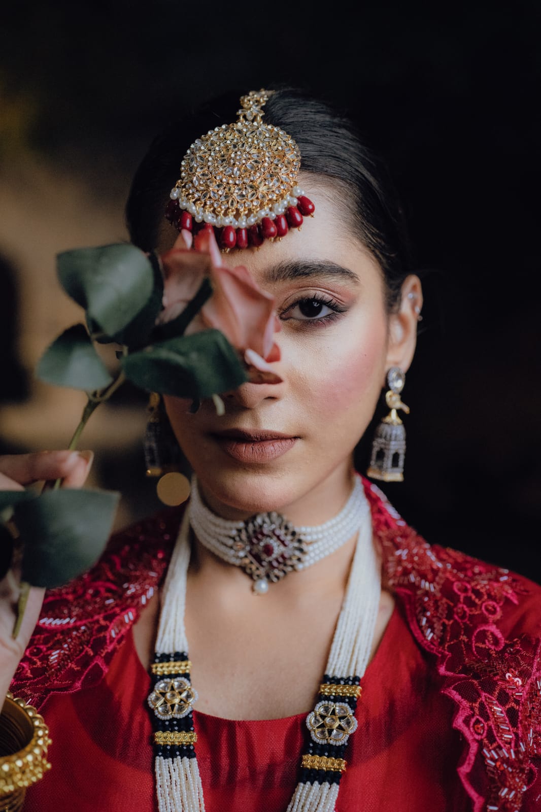 Woman holding the flower in her hand.