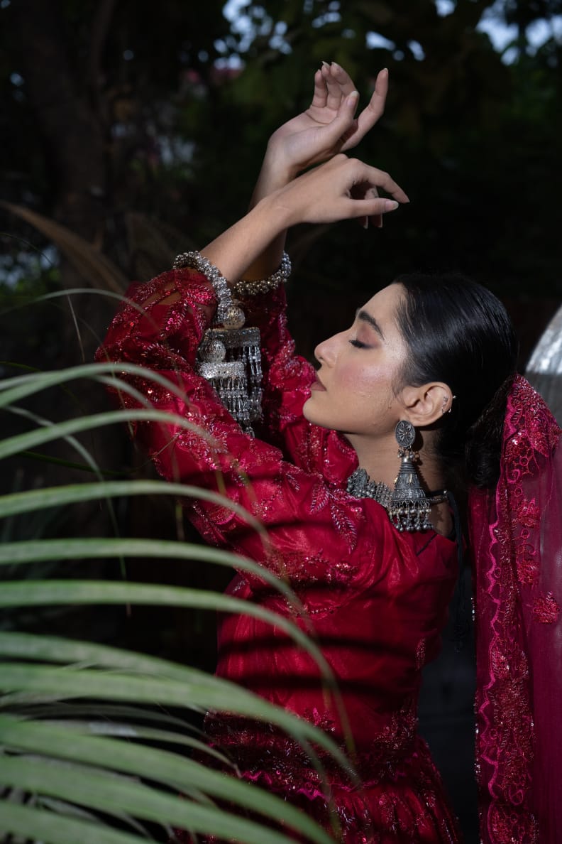 Joyfully dancing while showcasing her jewelry.