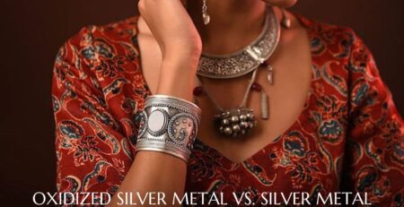 A woman displaying her jewelry with an oxidized finish.