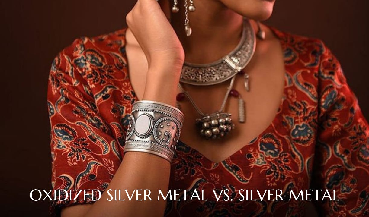 A woman displaying her jewelry with an oxidized finish.